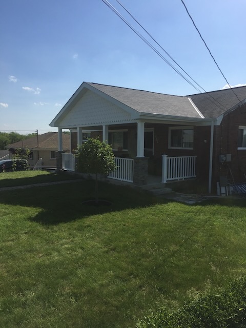 Covered front porch with stone columns