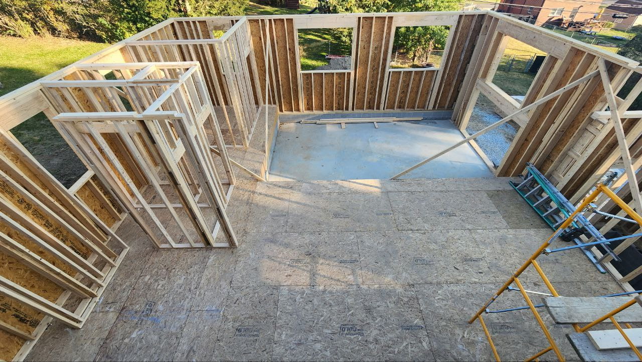 Aerial view of wood-frame room addition under construction