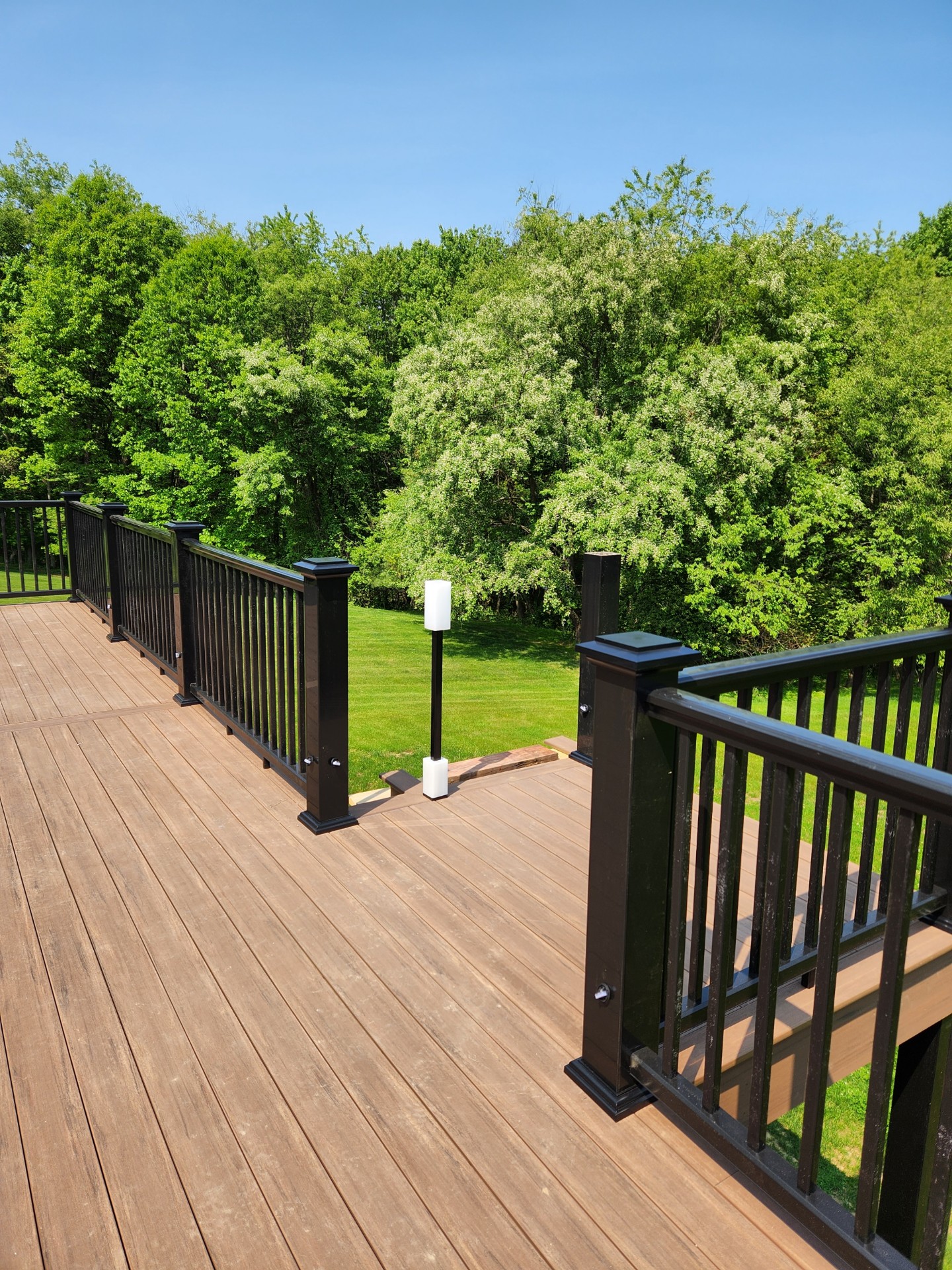 Composite deck with black railing at sunset