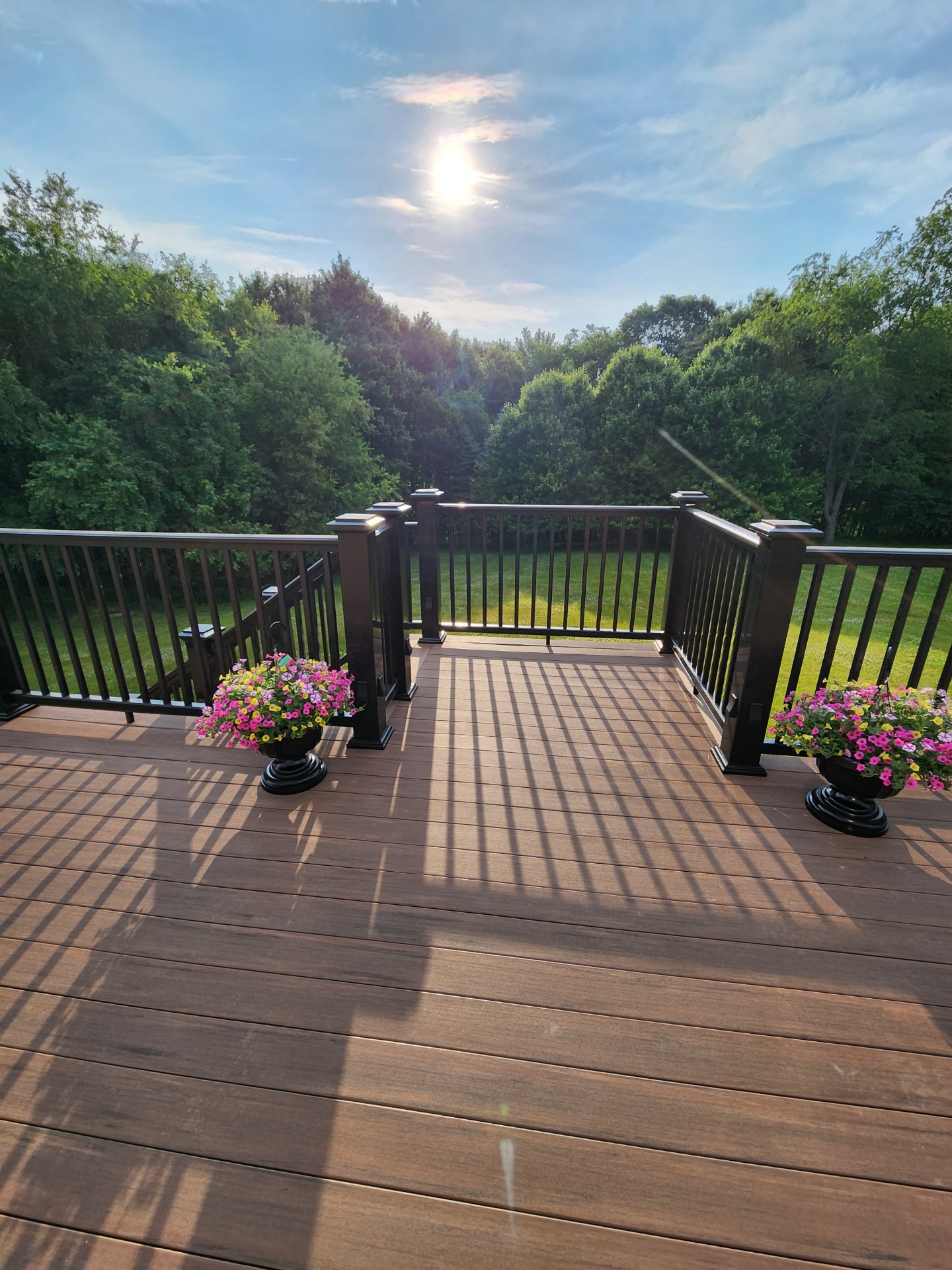 Composite deck with planter corners at sunset