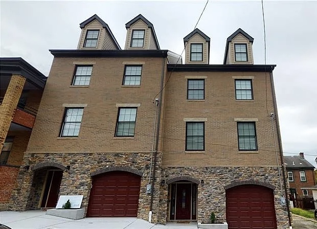 Completed three-story brick and stone townhome