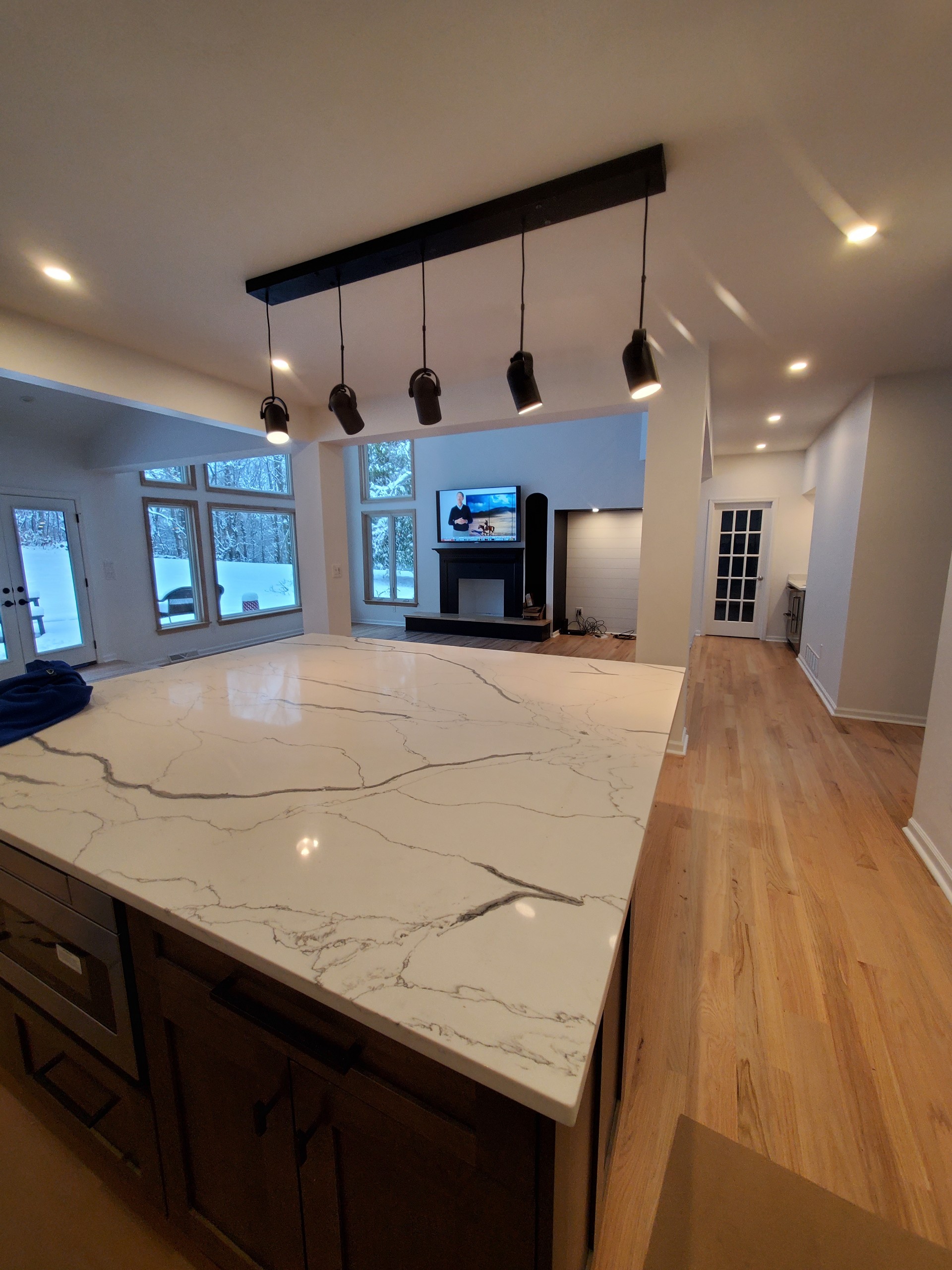 White kitchen with quartz island and pendant lights