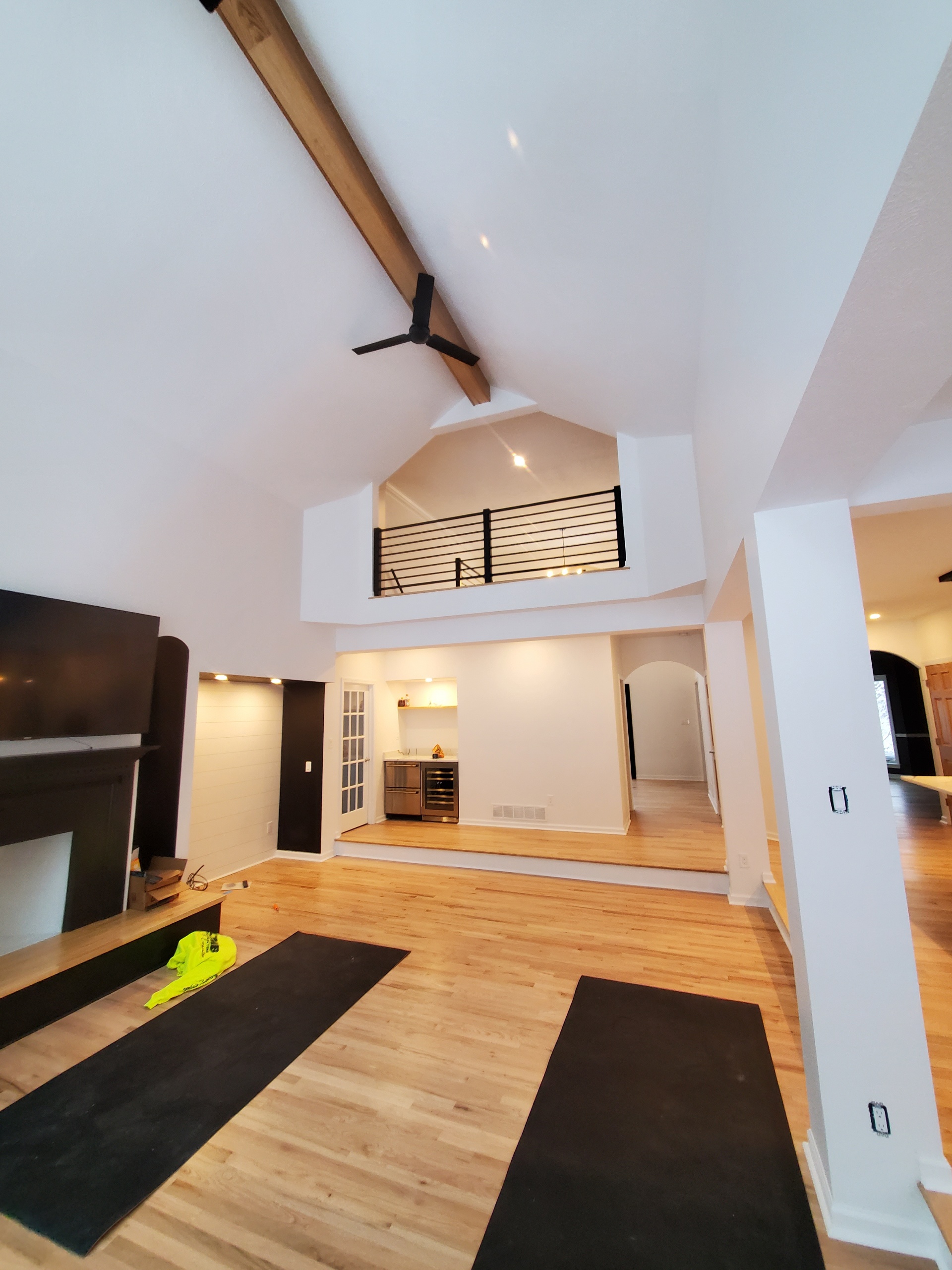 Vaulted ceiling great room with loft railing